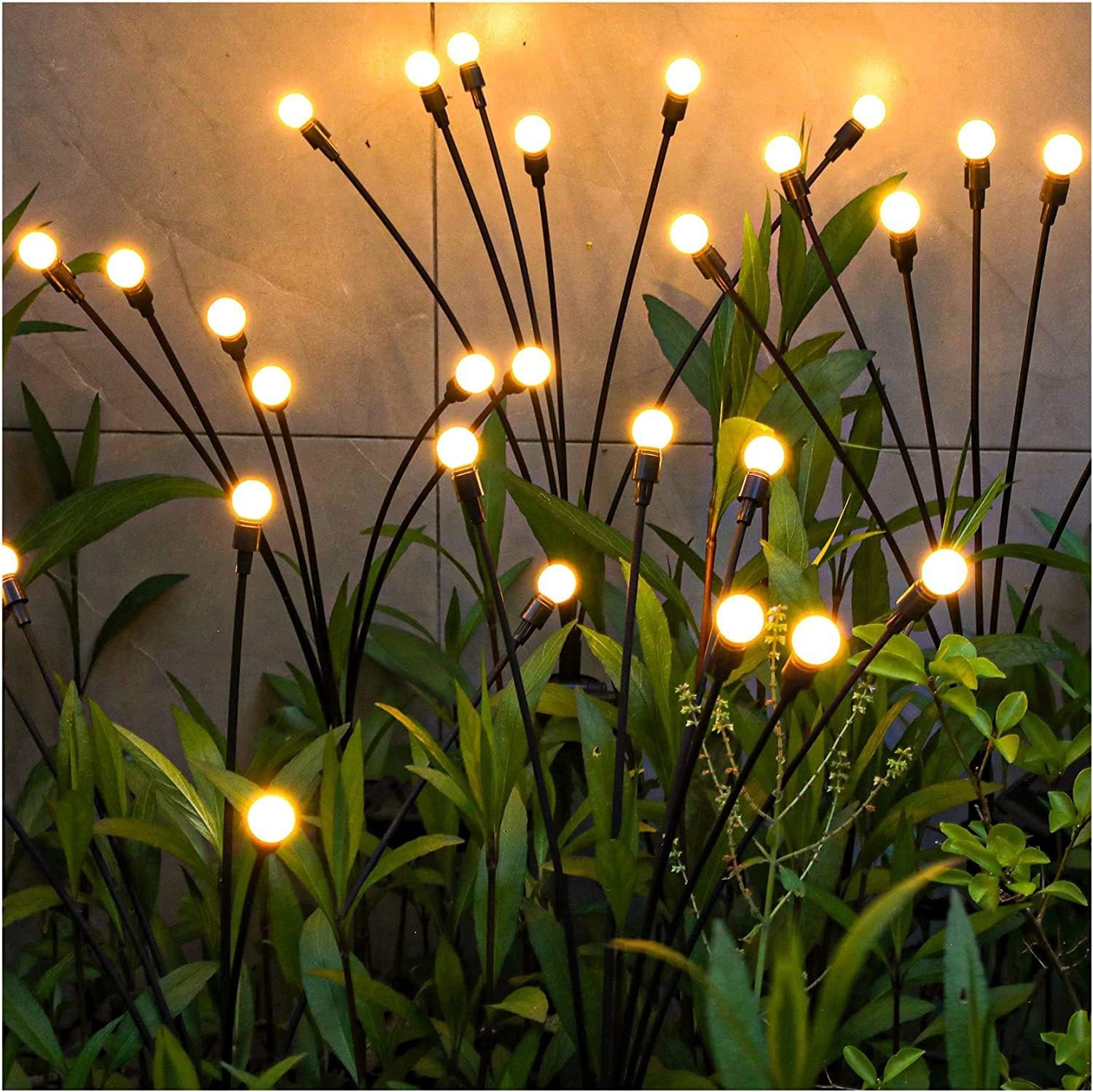 Outdoor garden stake lights with warm LED bulbs, arranged to mimic fireflies glowing among plants, adjustable stems for customizable layout, perfect for adding ambient lighting to pathways, flower beds, or landscapes, waterproof and weather-resistant design for year-round use in gardens, yards, or patios, creating a charming and cozy atmosphere for outdoor decor.